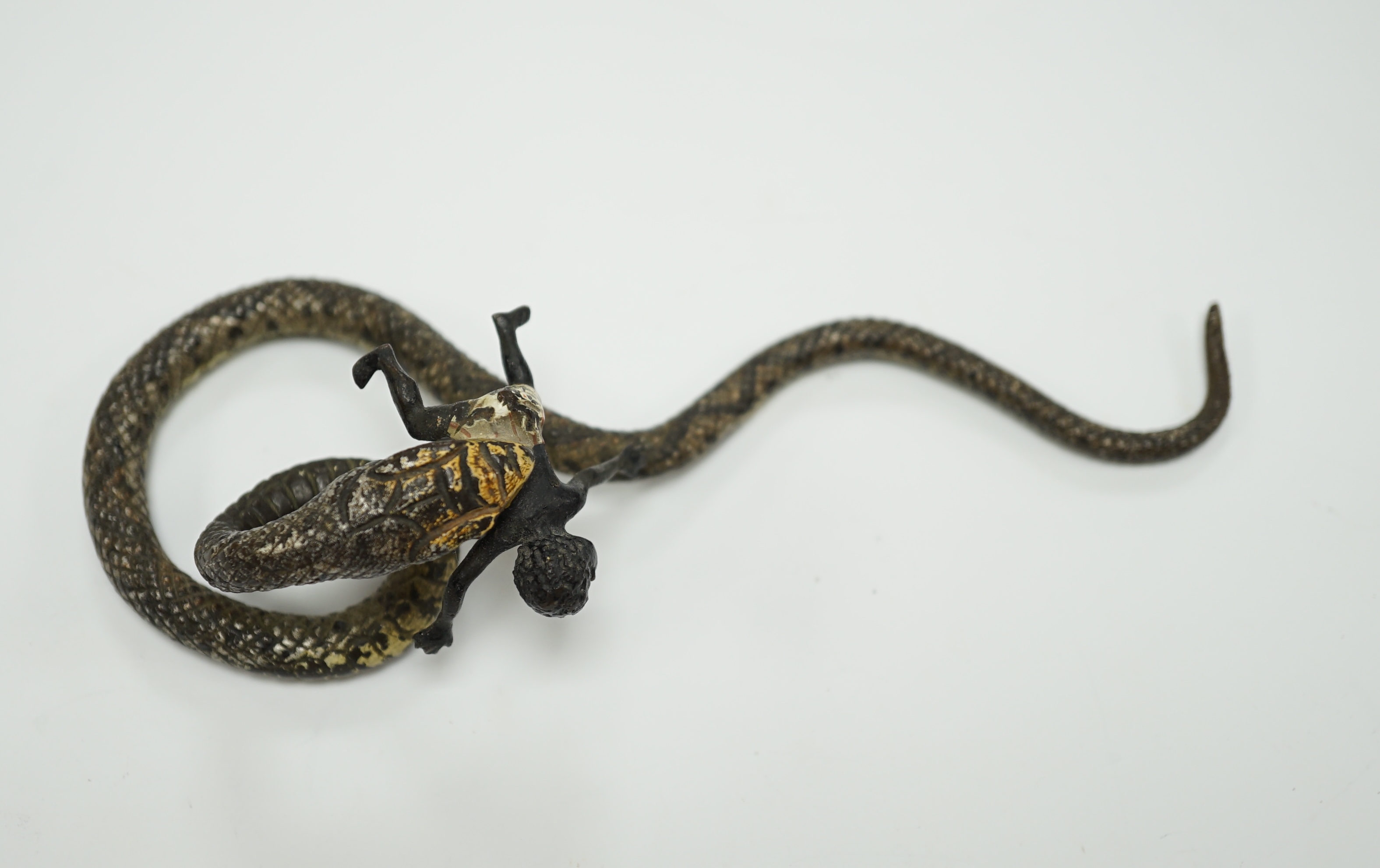 A Viennese cold painted bronze snake devouring a man, 14cm long